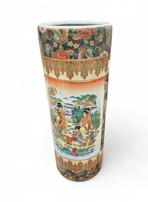 Lot 770 - Japanese ceramic stick stand with figural decoration.