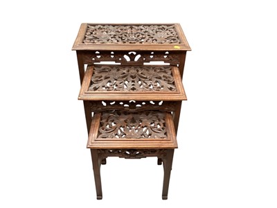 Lot 1302 - Nest of four occasional tables with leaf carved decoration, together with a folding table