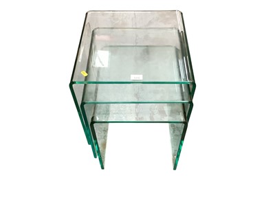 Lot 1310 - Nest of three glass occasional tables, together with a nest of two