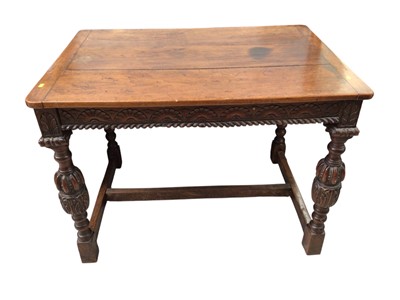 Lot 5393 - Antique carved oak table with plank top and carved cup and cover baluster legs joined by stretchers