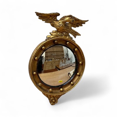 Lot 5394 - Regency style convex wall mirror in giltwood frame with eagle surmount