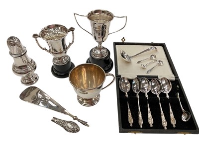Lot 1035 - Group of silver to include two small trophies on stands, cup with handle, castor, small ladle, three salt spoons, silver handled shoe horn and plated spoons in case