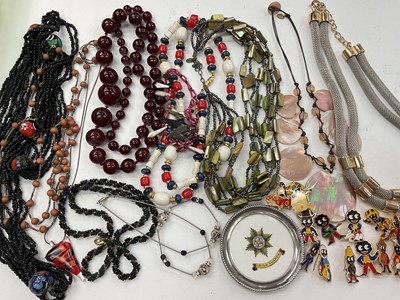 Lot 944 - Group of vintage and later necklaces, simulated cherry amber necklace, silver mounted ceramic Irish Guards pin dish and a collection of enamelled Golly pins
