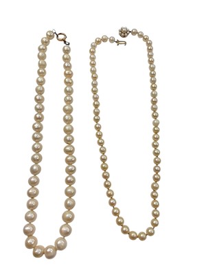 Lot 949 - Two cultured pearl single string necklaces, one with 9ct gold pearl flower head cluster clasp, the other with 15ct gold clasp