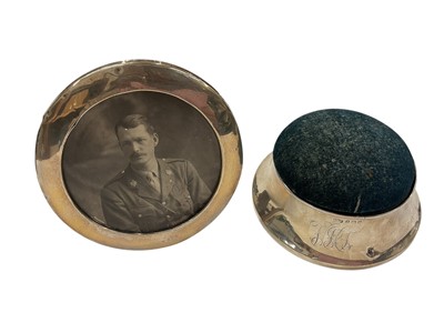 Lot 953 - Edwardian silver mounted pin cushion and silver circular photograph frame (2)