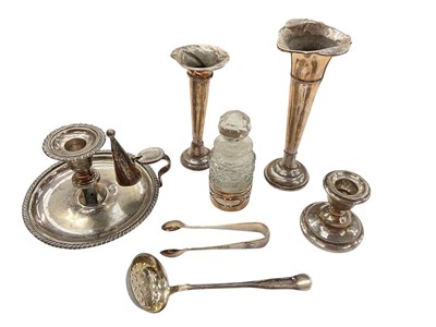 Lot 954 - Two silver spill vases, silver mounted glass bottle and a silver candlestick
