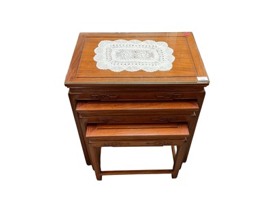 Lot 1440 - Nest of three Chinese hardwood coffee tables with glass tops and similar long coffee table with glass top
