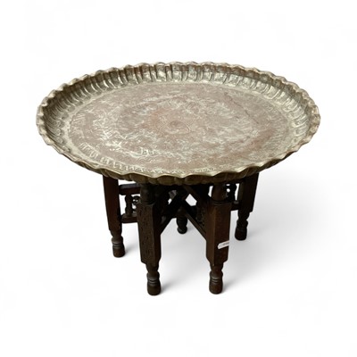 Lot 43 - Middle Eastern engraved metal dish on folding wooden stand