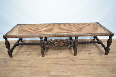 Lot 1229 - 1920s Jacobean revival oak framed stool with canework top