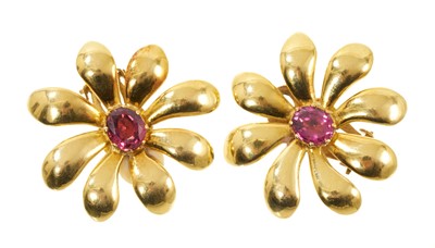 Lot 572 - Pair of yellow metal flower earrings with a central garnet