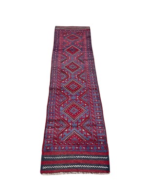 Lot 1493 - Meshwani runner with five central medallions on red and blue ground, 261cm x 64cm