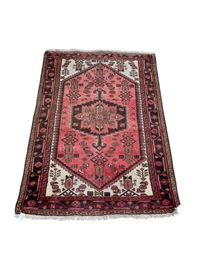 Lot 1498 - Eastern rug with central medallion on red and beige ground, 148cm x 102cm