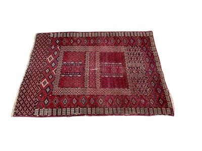 Lot 1296 - Tekke rug, with typical geometric ornament on claret ground, 146cm x 114cm