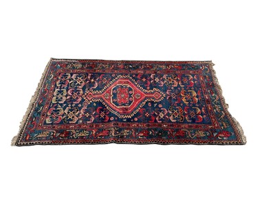 Lot 1500 - Eastern rug with central medallion on red and blue ground, 185.5cm x 112cm
