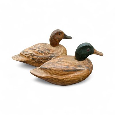 Lot 422 - Two antique grained pine decoy ducks with glass eyes, (2).