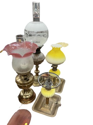 Lot 520 - Victorian brass oil lamp, pair brass and yellow tinted glass peg lamps, reproduction oil lamp and musical Regency clock base (5)