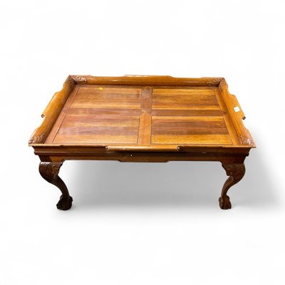 Lot 1519 - Carved coffee table on cabriole legs with claw and ball feet, 97cm x 67cm x 47cm high together with an Ibex elbow chair (2)