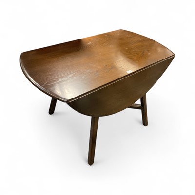 Lot 1520 - Ercol drop leaf dining table and a set of four matching chairs