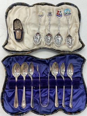 Lot 1003 - Set of six silver teaspoons and pair silver sugar tongs in fitted case, four silver and enamel souvenir spoons and silver thimble in case
