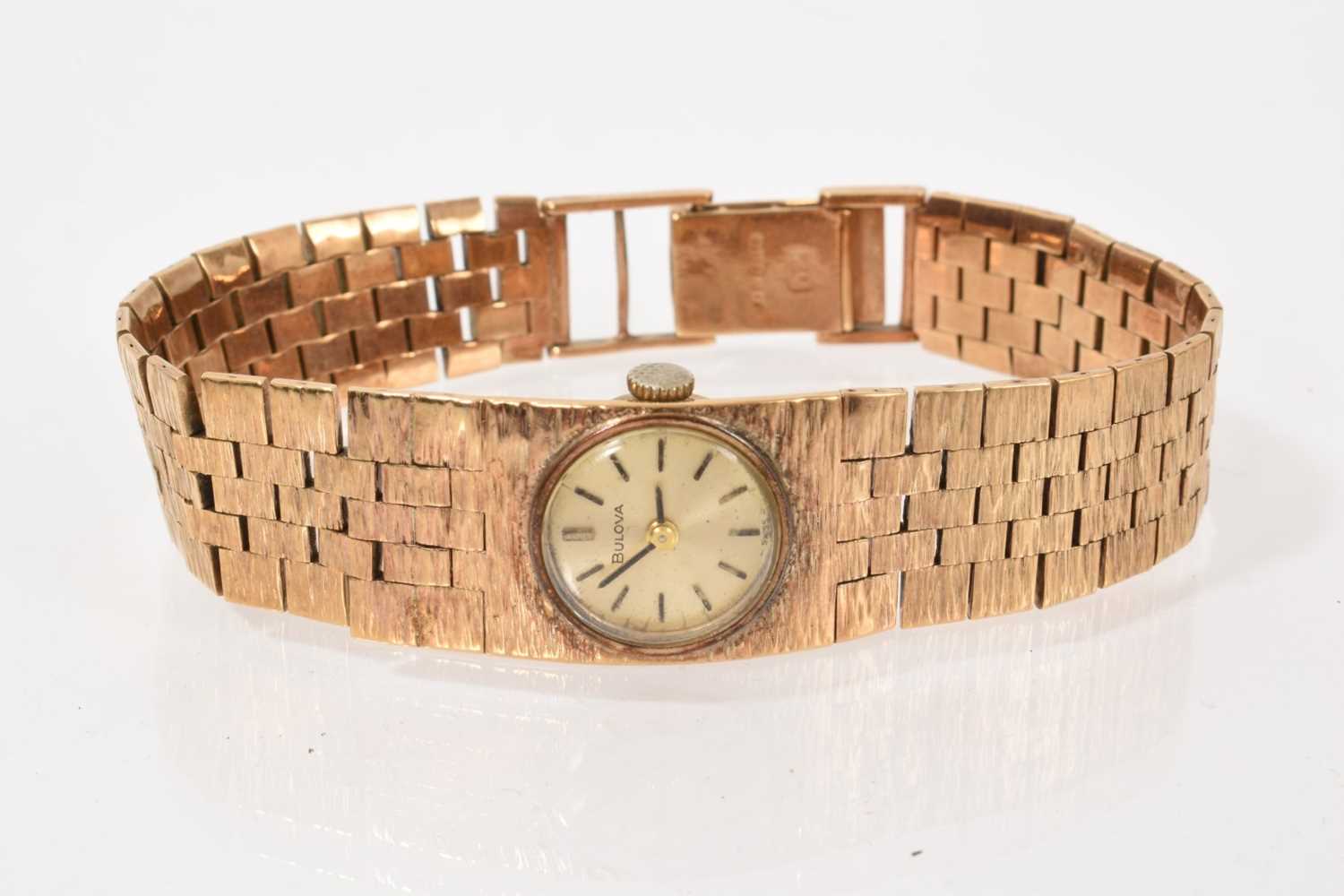 Lot 779 - 1970s ladies' Bulova 9ct gold wristwatch with an integral articulated textured bracelet