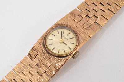 Lot 779 - 1970s ladies' Bulova 9ct gold wristwatch with an integral articulated textured bracelet