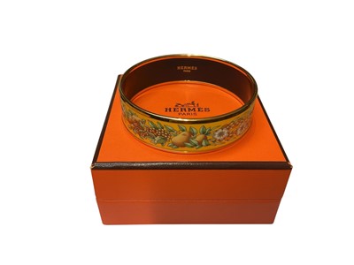 Lot 38 - Hermès yellow enamel bangle with flower, wheat and fruit decoration, in box