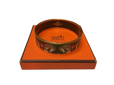 Lot 39 - Hermès green enamel bangle with horse decoration, in box