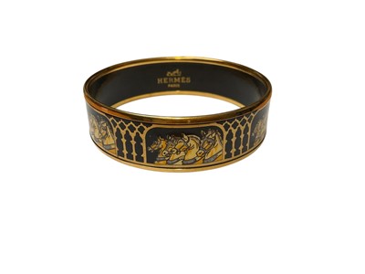 Lot 40 - Hermès black enamel bangle with horse decoration