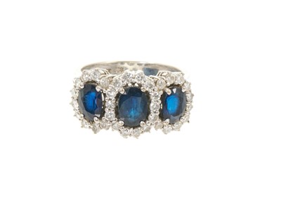 Lot 628 - Sapphire and diamond triple cluster ring