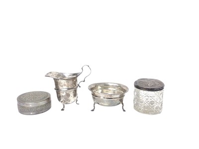 Lot 229 - Silver sugar bowl and matching cream jug (Sheffield 1911 and 1912), together with a silver mounted glass jar and a white metal pot with cover (4)