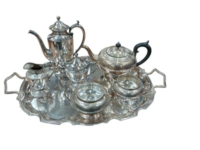Lot 501 - Silver plated two handled serving tray of oval form, together with a three piece silver plated tea set and a silver plated three piece coffee set.