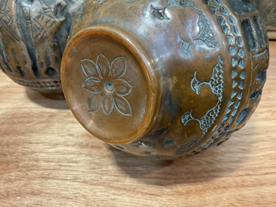 Lot 5091 - Pair of Islamic copper bottle vases and covers with relief decoration, 36.5cm high