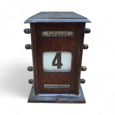 Lot 5040 - Edwardian oak calendar measuring approximately 20.5cm tall