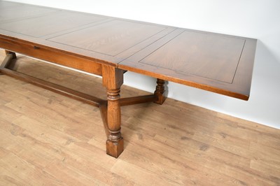 Lot 1210 - Good quality 18th century style draw-leaf refectory table and en-suite set of fourteen chairs by Stewart Linford