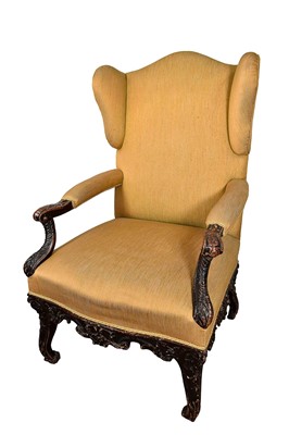 Lot 1220 - 18th century Continental wing armchair, with heavily carved scroll arms on cabriole legs