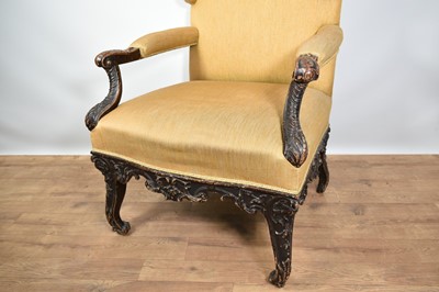 Lot 1220 - 18th century Continental wing armchair, with heavily carved scroll arms on cabriole legs