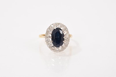 Lot 643 - Sapphire and diamond cluster ring in platinum setting on 18ct gold shank