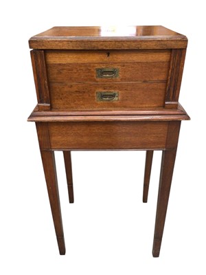 Lot 494 - Edwardian blond oak two drawer canteen on stand, the canteen with hinged top and two drawers enclosed by hinged stiles, with flanking