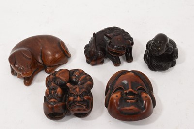 Lot 845 - Japanese carved boxwood netsuke, in the form of a reclining hound, 5cm long, together with four other antique boxwood netsukes