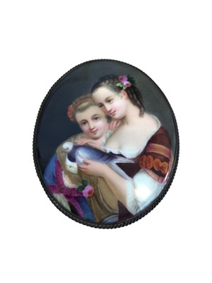 Lot 5107 - Late 19th century porcelain plaque depicting two girls and a dove, in white metal brooch frame