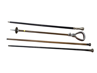 Lot 5111 - Two silver topped walking sticks and one white metal stick, together with a shooting stick