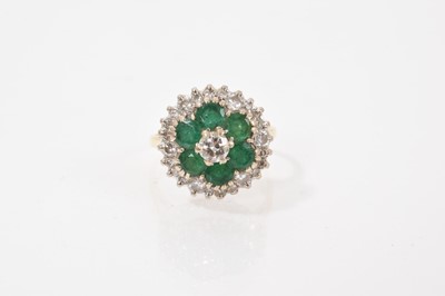 Lot 606 - Emerald and diamond cluster ring with mixed-cut emeralds and brilliant cut diamonds in tiered flaw setting on 18ct gold shank, estimated total diamond weight approximately 0.75cts. Hallmarked Lo...