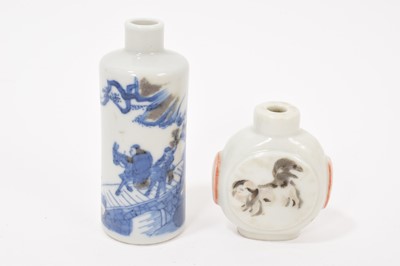 Lot 313 - Chinese iron red enamelled snuff bottle with Daoguang mark, and a blue and white snuff bottle decorated with figures (2)