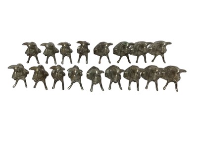 Lot 436 - Group of seventeen novelty white metal menu holders in the form of seated pigs, each 1.9cm in height, all at 4.5ozs (17).
