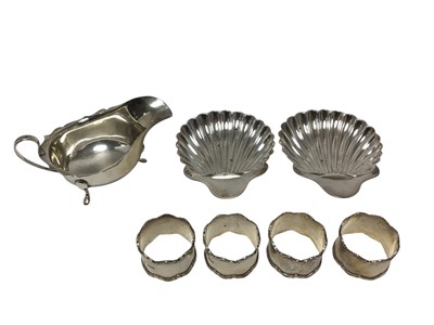 Lot 445 - Pair of Victorian silver shell shaped dishes, (London 1891), together with a George V silver sauce boat, (Birmingham 1930) and four George V silver napkin rings (Sheffield 1935), all 12ozs.