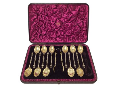 Lot 446 - Victorian part set of silver gilt teaspoons and sugar tongs in the gothic style, the tongs with design registration number- Rd. No. 45926, each teaspoon with engraved initials to bowl, (London 1...