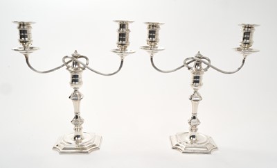 Lot 448 - Pair of Edwardian candelabra, in the Georgian style with knopped stems and square bases, each with removable fittings, with twin branches, reeded arms and removable sconces, (Birmingham 1903), m...