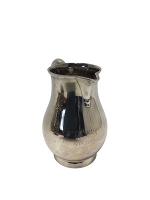 Lot 466 - 1930s silver beer jug of baluster form, with engraved inscription and scroll handle