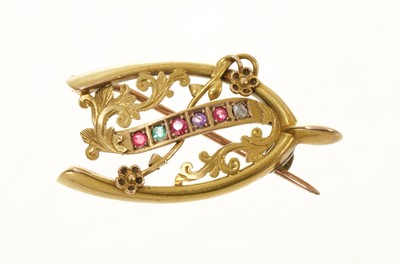 Lot 707 - Victorian gold and multi-gem 'Regard' brooch with a lucky wishbone design, engraved '15ct', length 32mm.