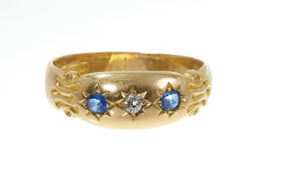 Lot 709 - Victorian 18ct gold sapphire and diamond three stone ring in gypsy setting, Chester 1900, ring size P.